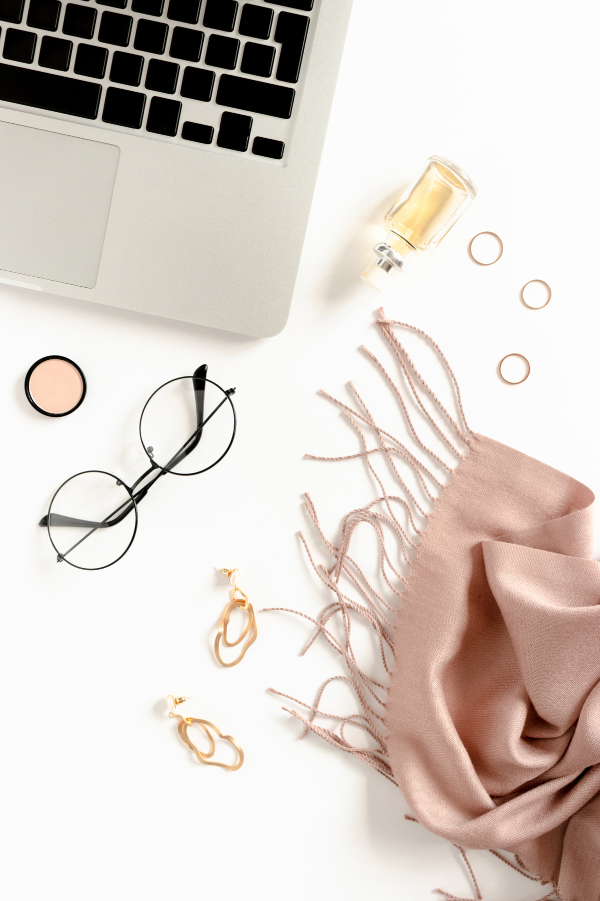 Fashion flatlay with laptop, women's cosmetics and accessories